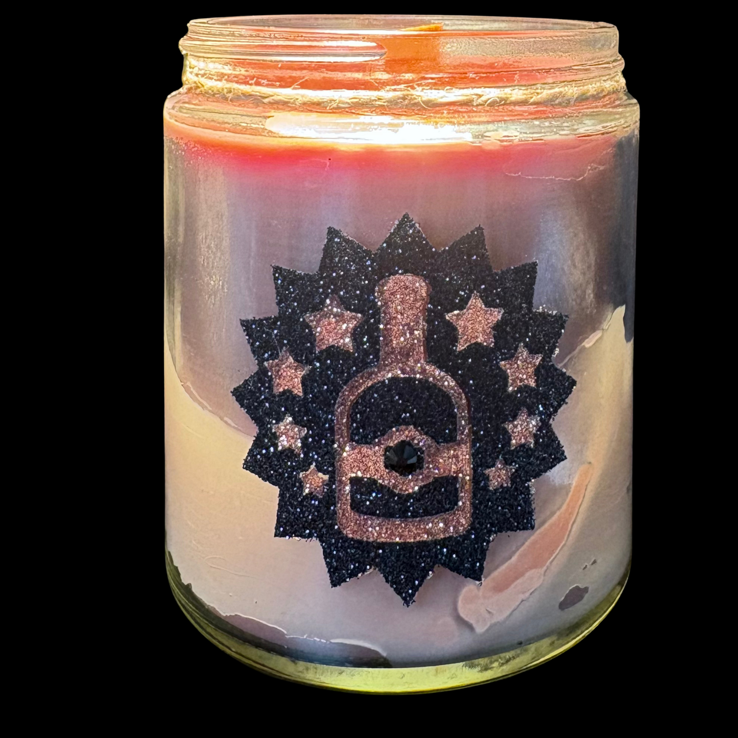 Candle in a jar with a decorative label featuring a bottle design on a white background