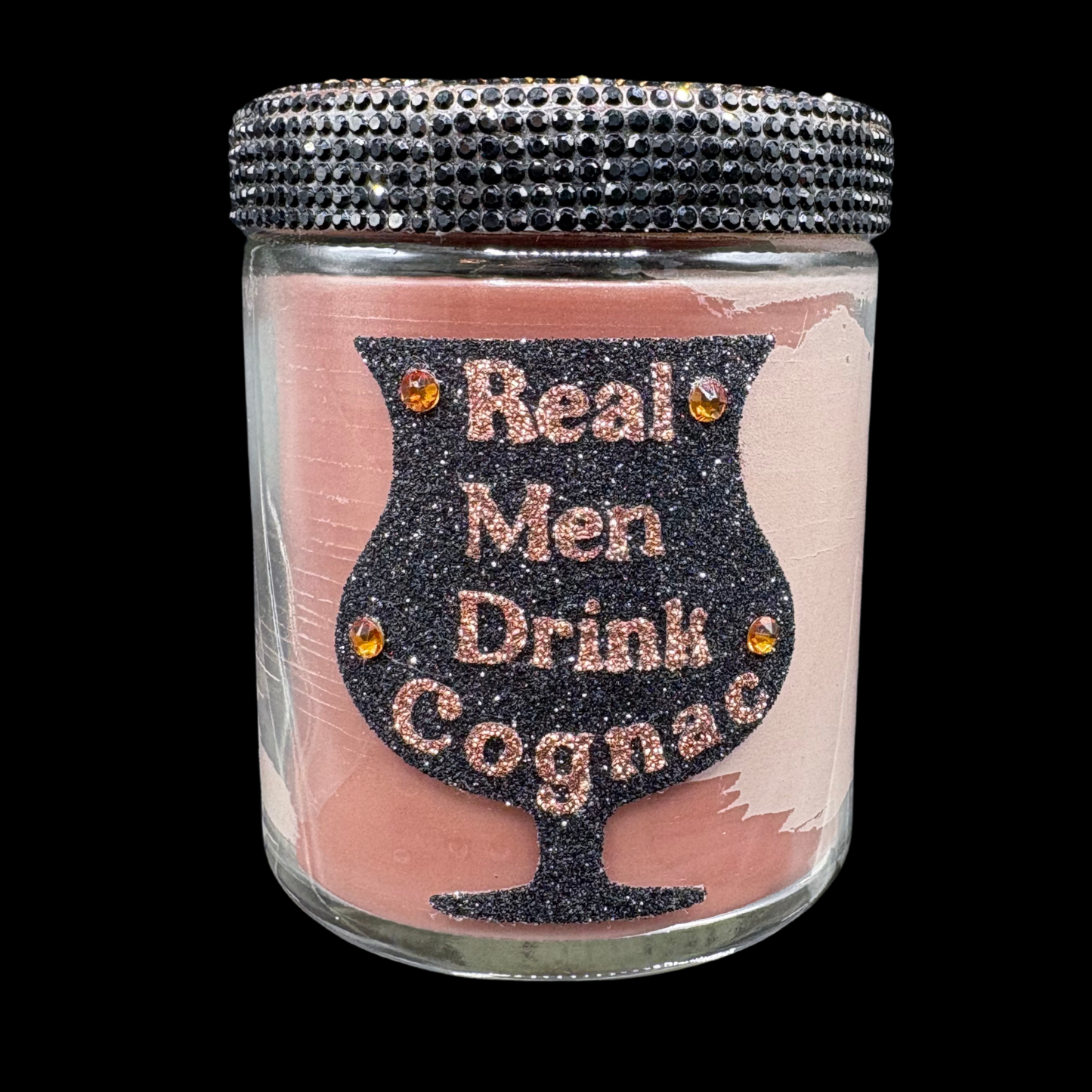 Jar with decorative lid and 'Real Men Drink Cognac' text on a pink background