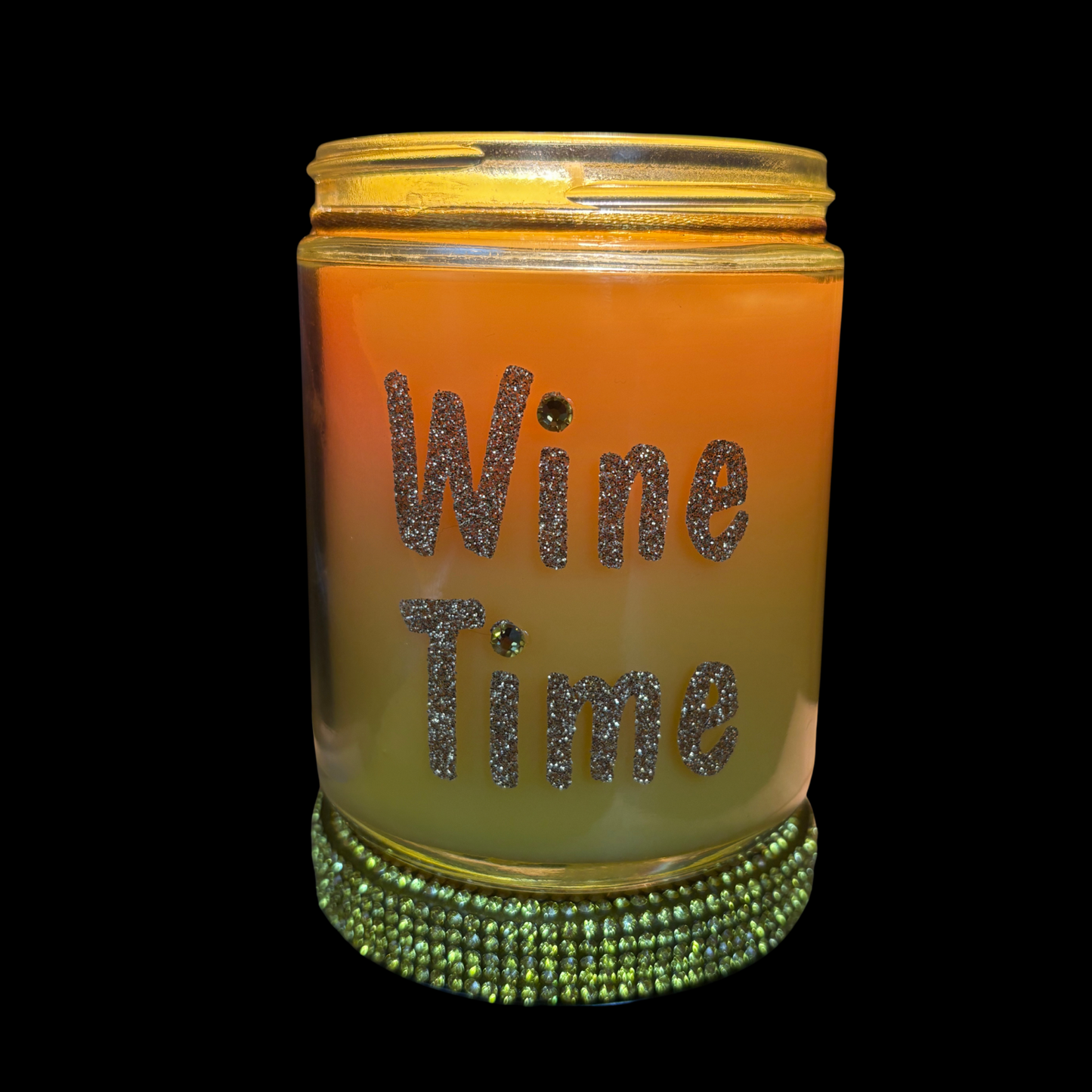 Candle jar with 'Wine Time' text and green gemstone band on a black background