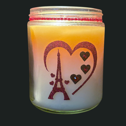 Candle in a jar with Eiffel Tower and heart design on a dark background