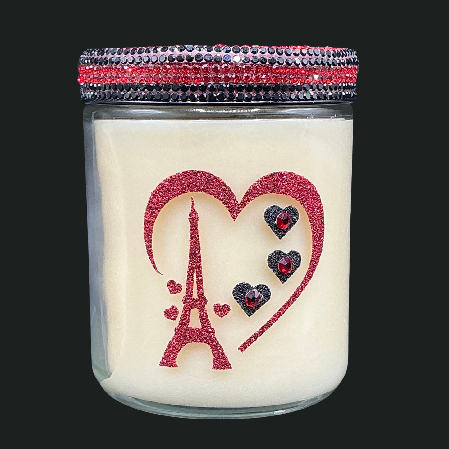 Candle with Eiffel Tower and heart design on a black background