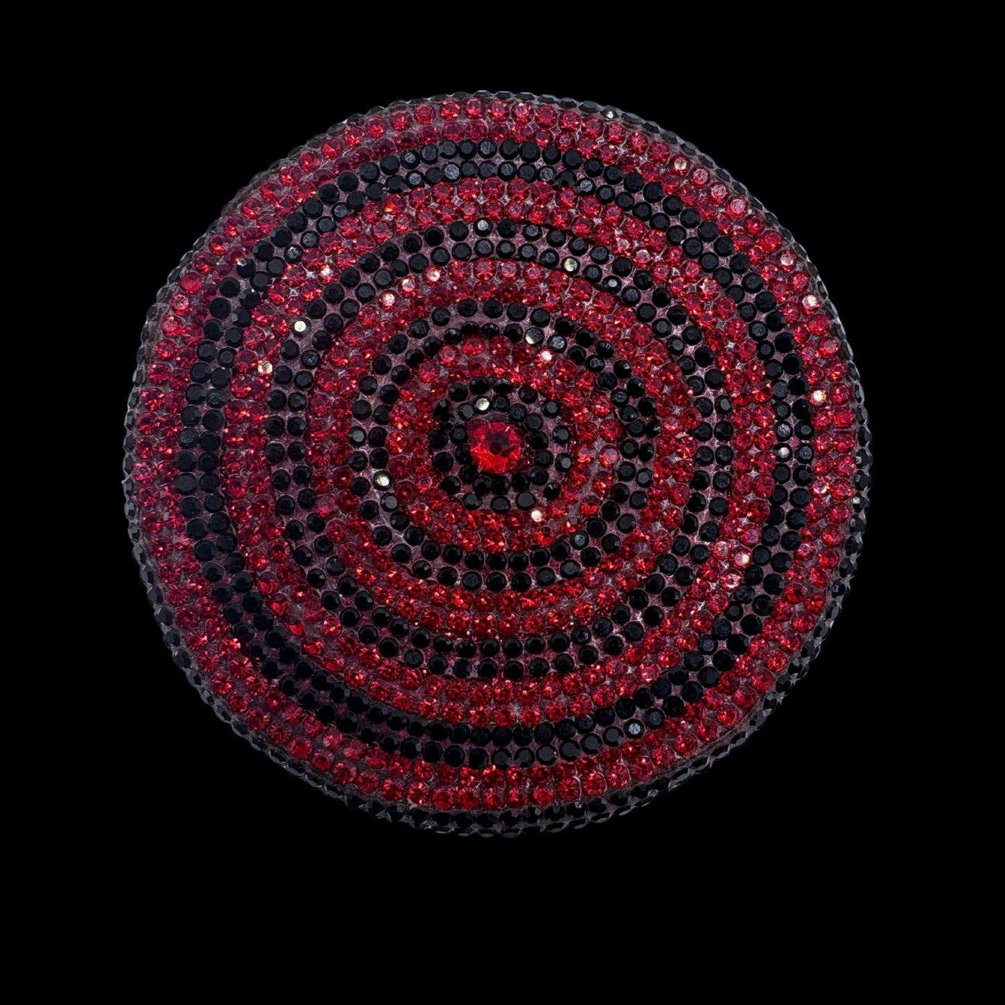 Circular design with red and black concentric circles on a black background