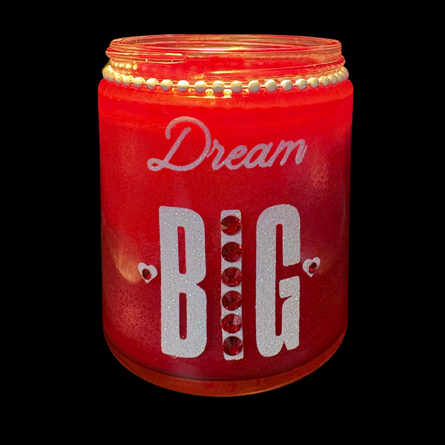 Red jar with 'Dream BIG' text and decorative elements on a black background