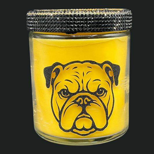 Glass jar with bulldog illustration and black rhinestone lid on a yellow background