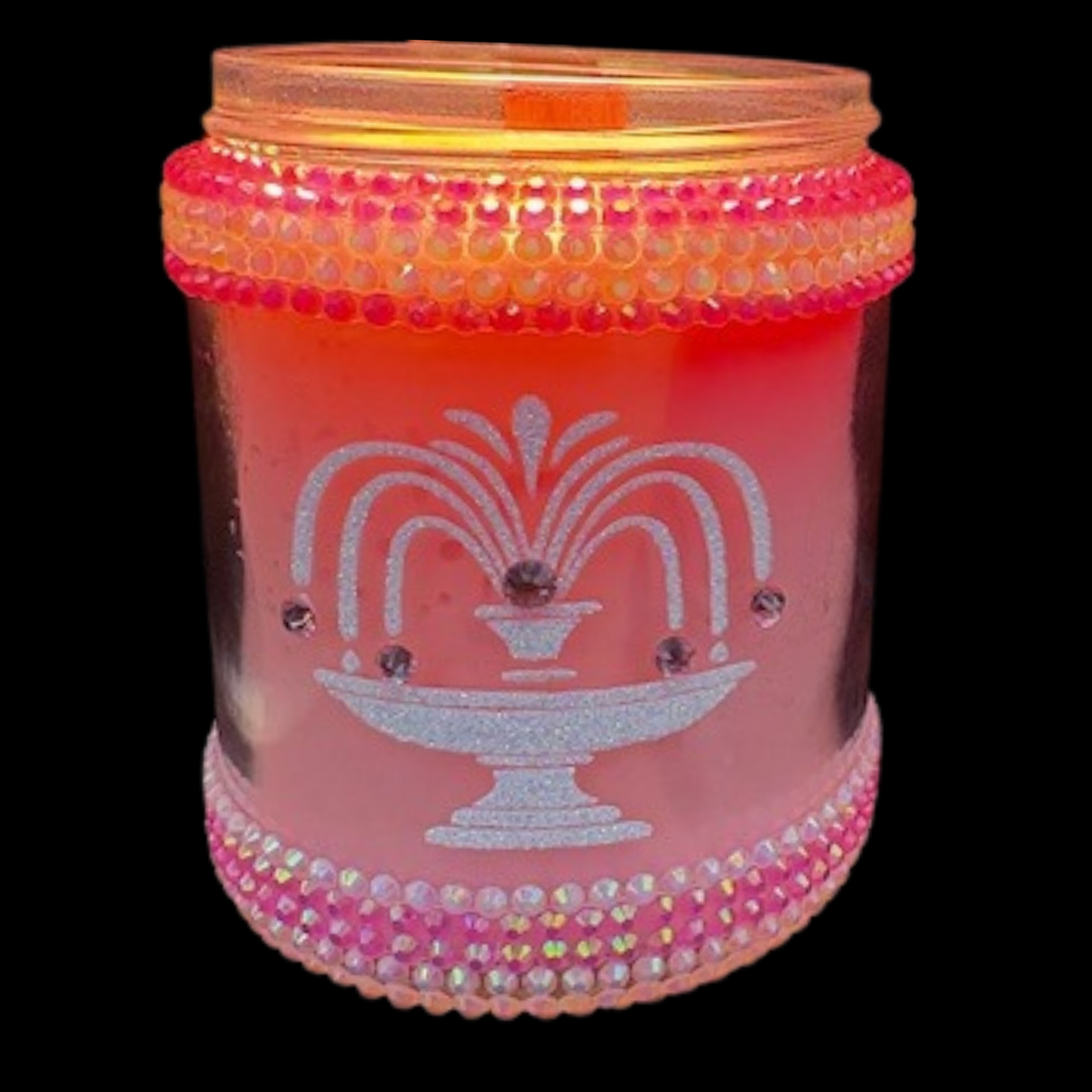 Decorative candle jar with pink and orange design on a black background