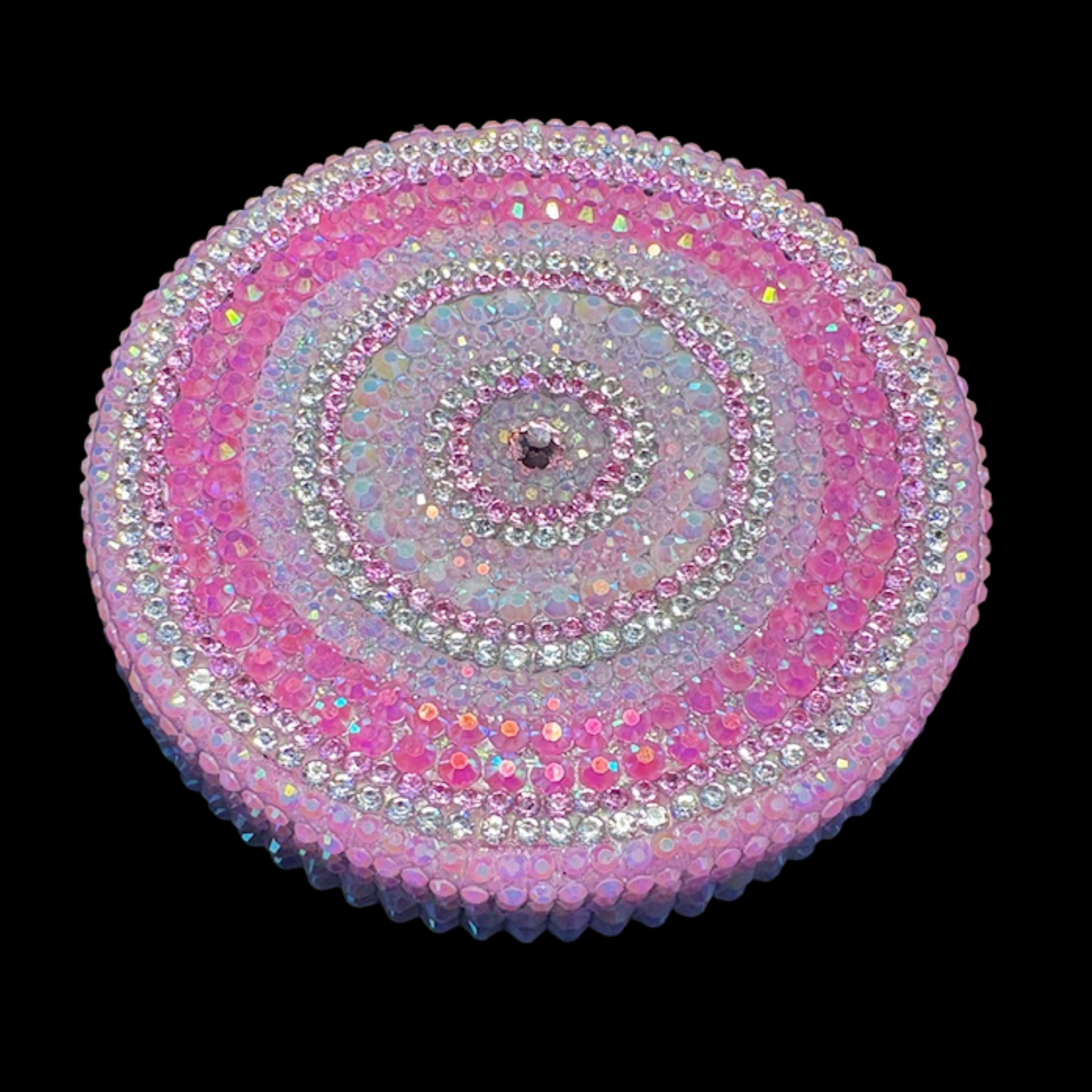 Circular pink and silver beaded design on a black background