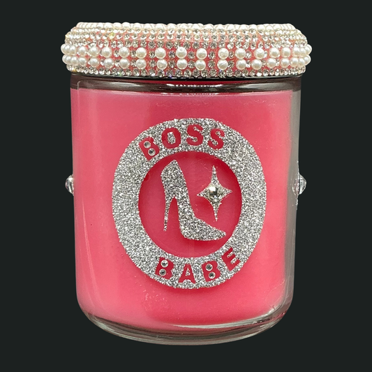 Pink jar with decorative lid featuring 'BOSS BABE' text and high heel design on a black background