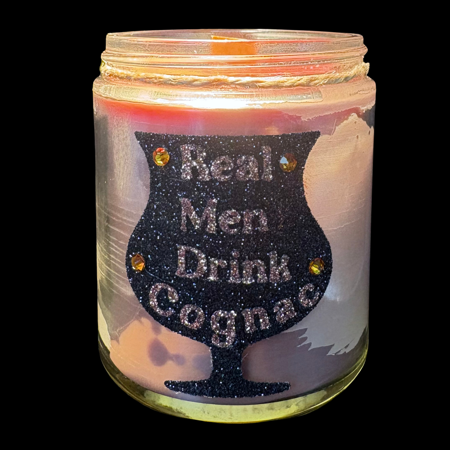 Candle in a jar with a humorous design and text on a black background