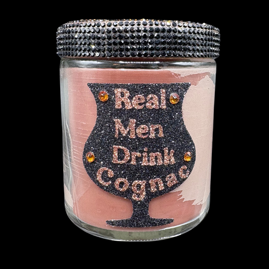 Jar with decorative lid and 'Real Men Drink Cognac' text on a pink background