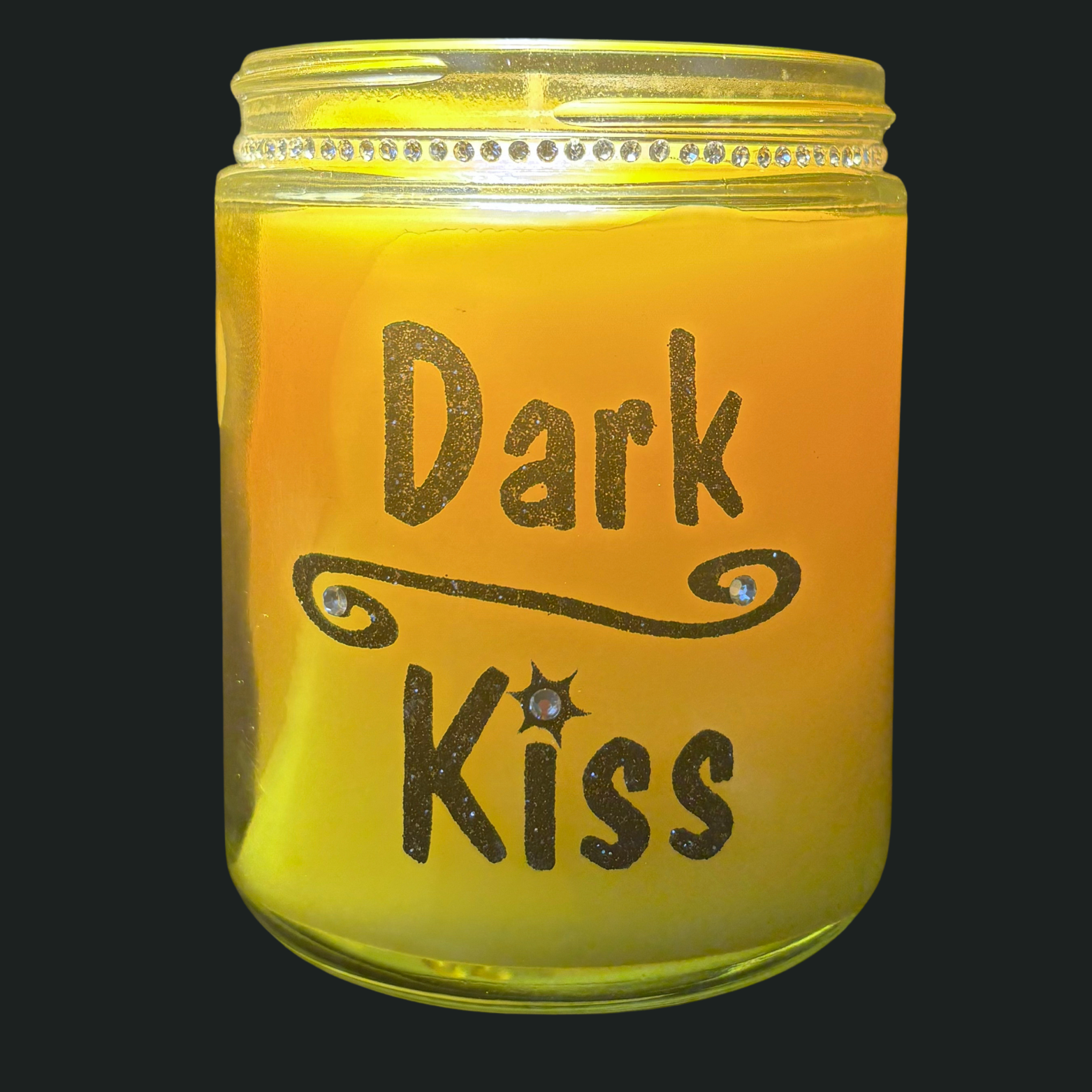 Candle in a jar with 'Dark Kiss' text on a black background