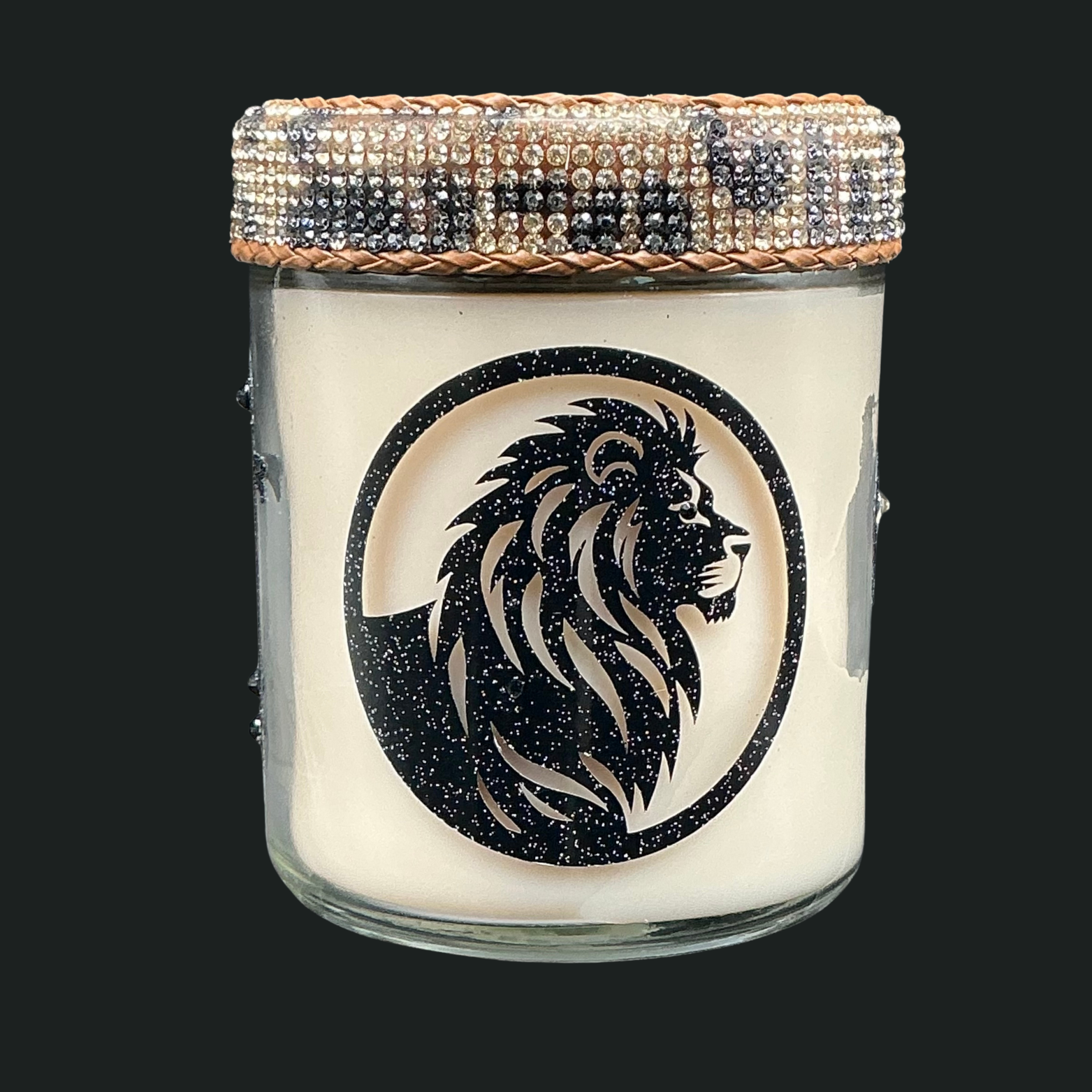 Candle jar with lion design and beaded lid on a black background