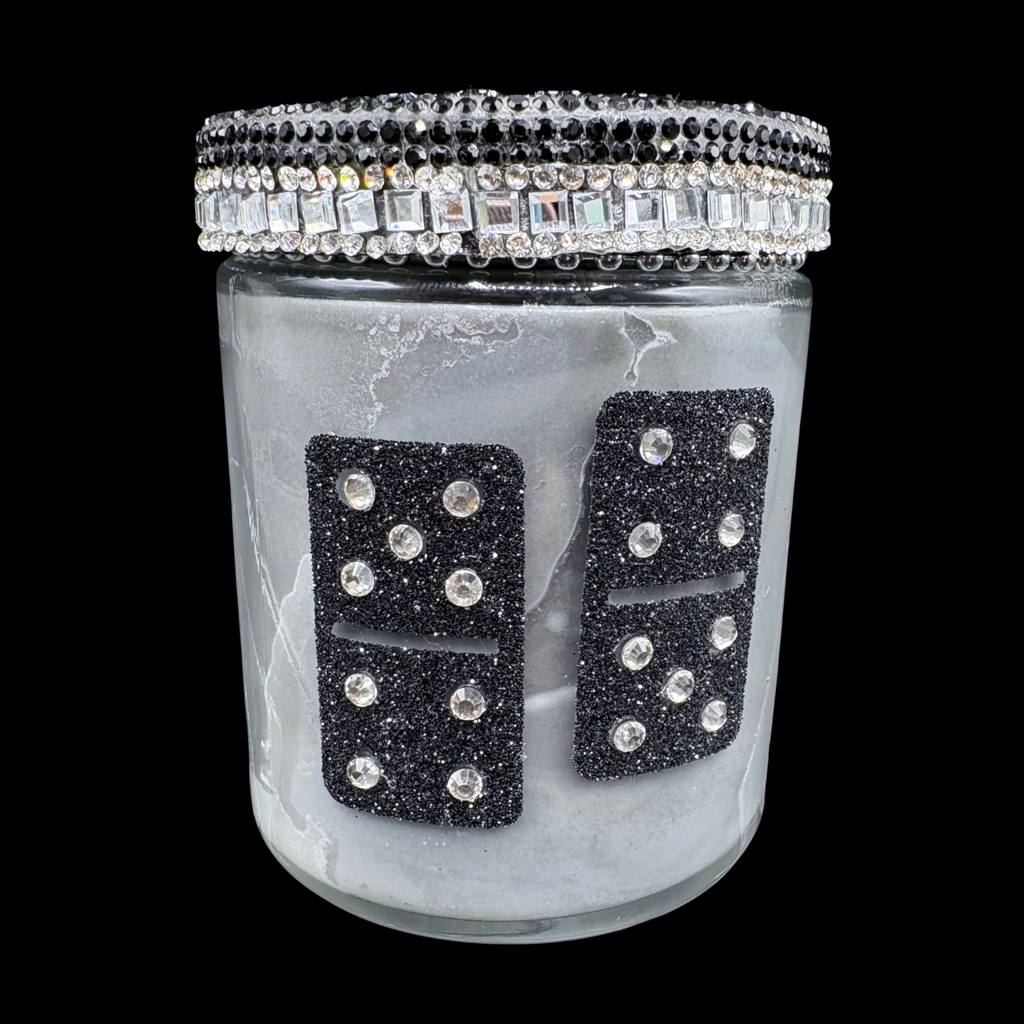Decorative jar with black rhinestone dominoes and crystal lid on a black background