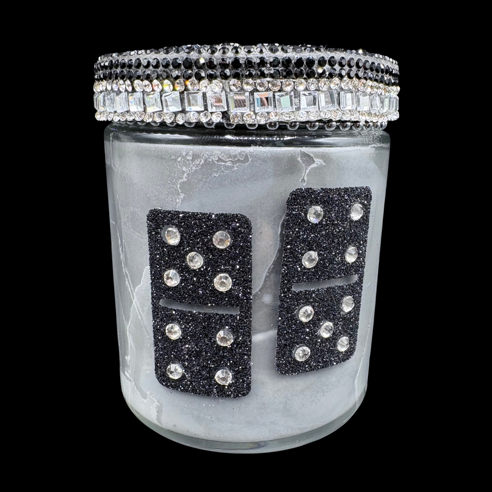 Decorative jar with black rhinestone dominoes and crystal lid on a black background