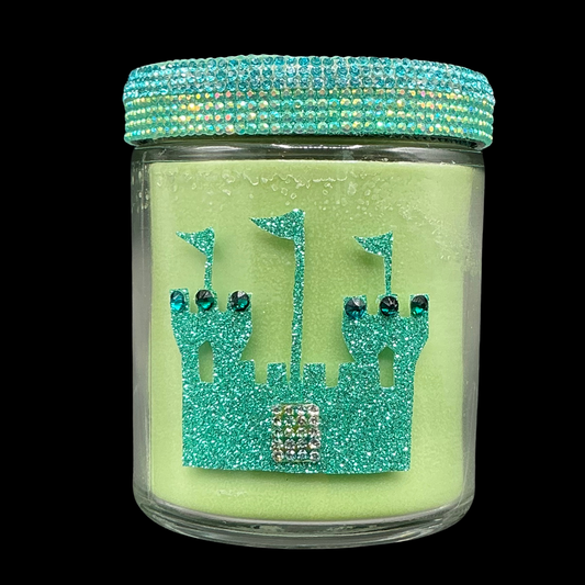 Green candle jar with decorative lid on a black background