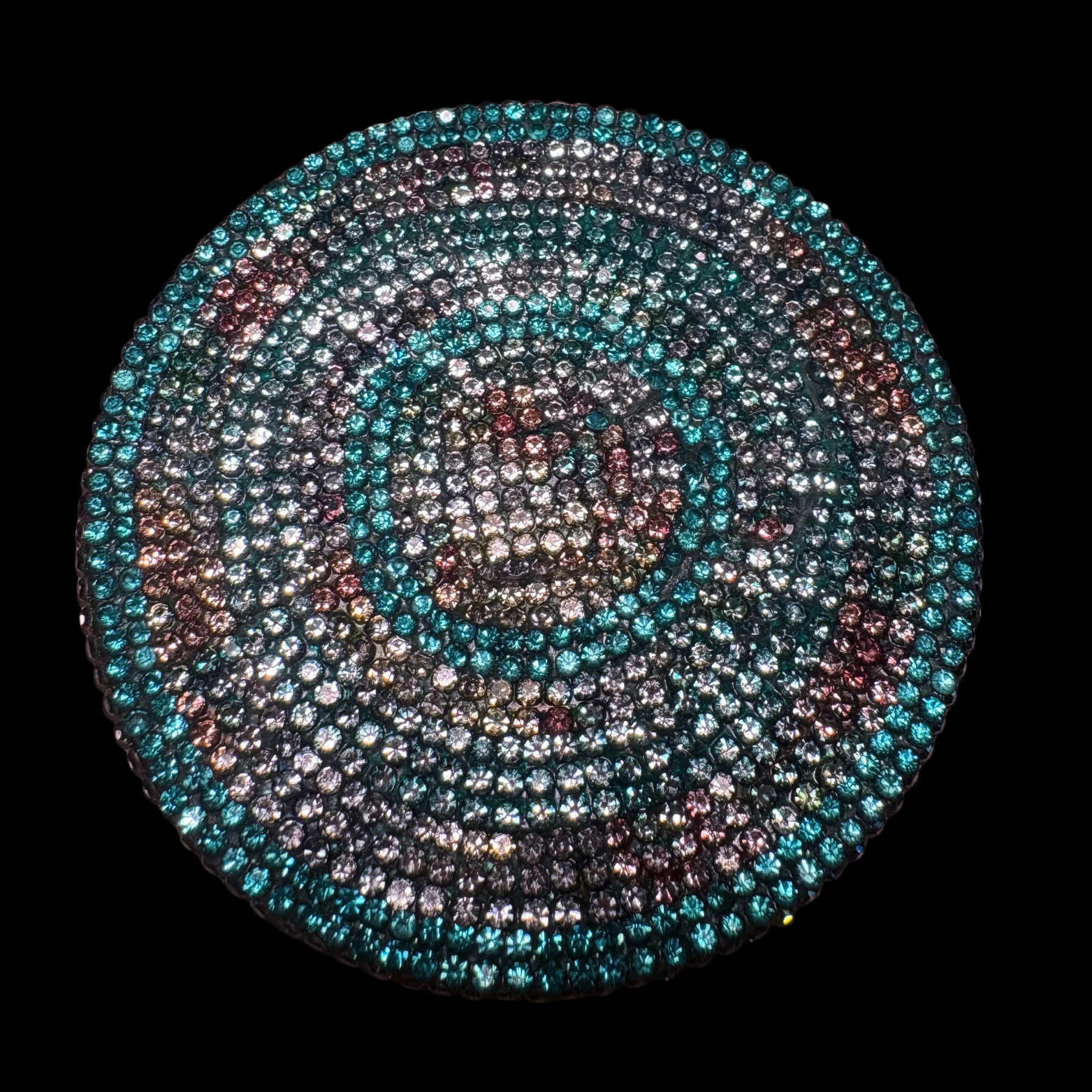 Circular pattern of multicolored stones on a black background