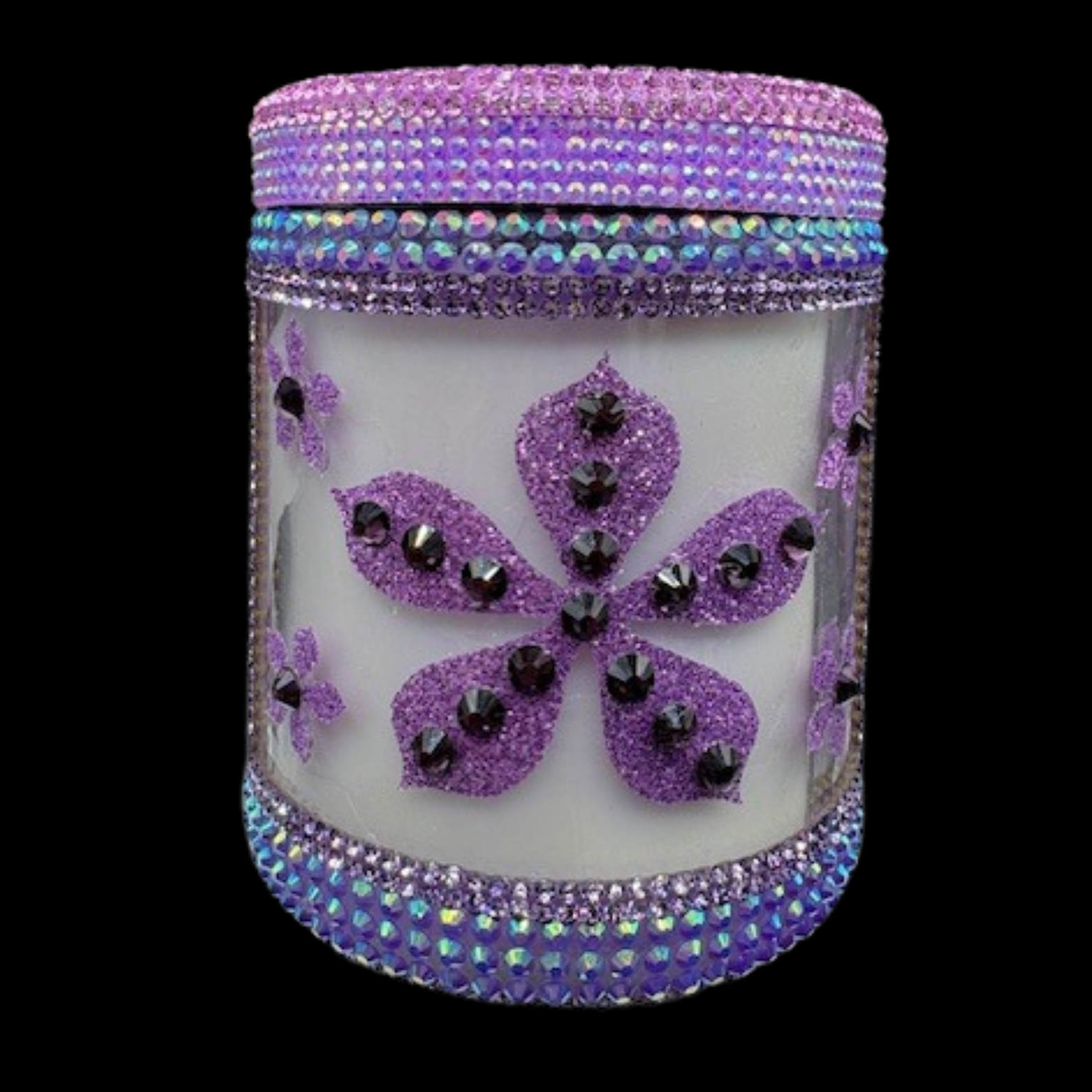Decorative candle with purple butterfly design and rhinestone embellishments on a white background