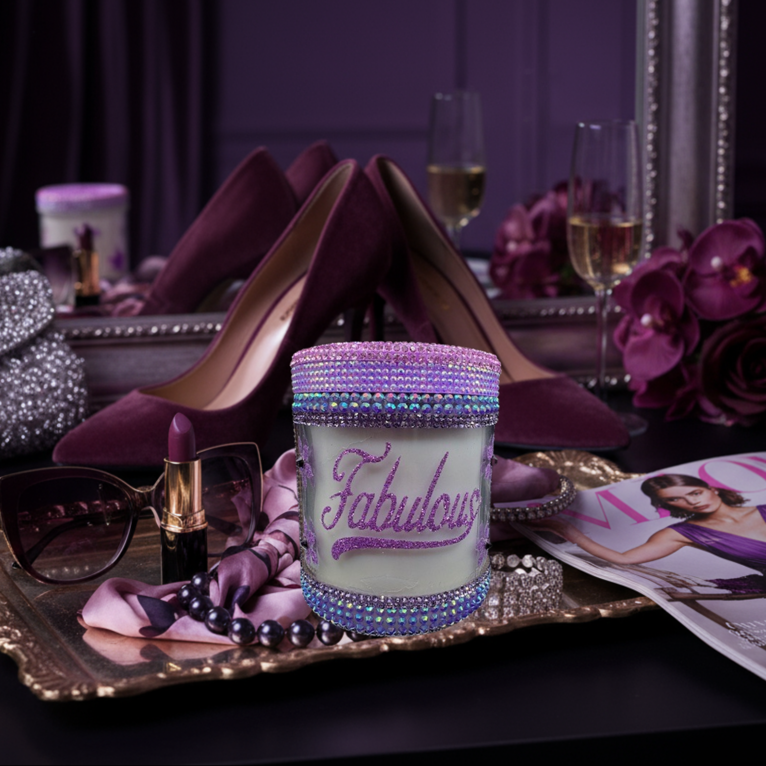 Decorative candle with 'Fabulous' text on a tray with high heels, lipstick, and flowers.