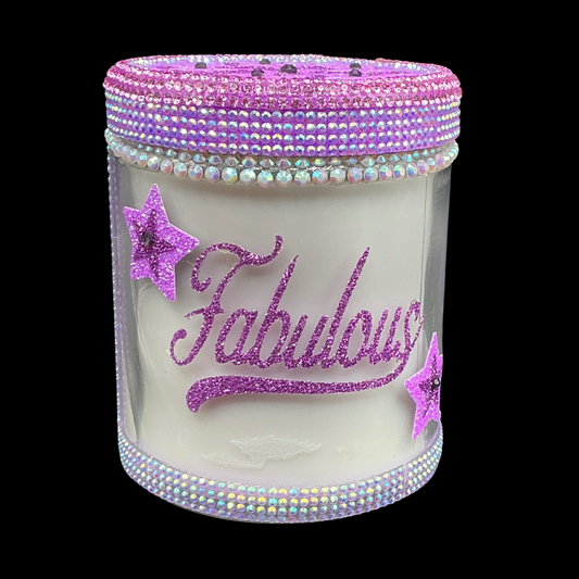 Candle jar with 'Fabulous' text and star decorations on a black background