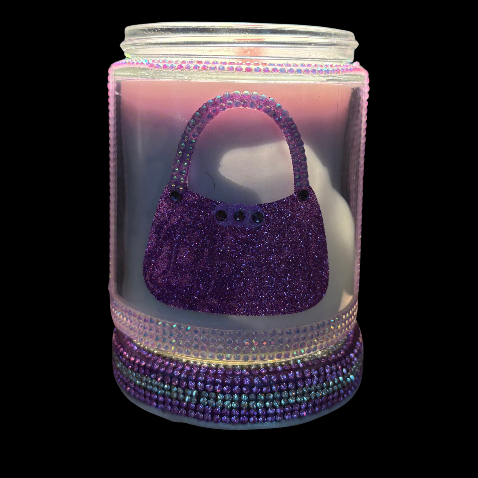 Decorative jar with a purple glittery handbag design on a white background