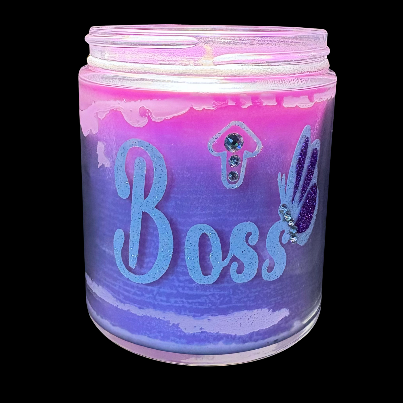 Candle jar with 'Boss' text and decorative elements on a black background