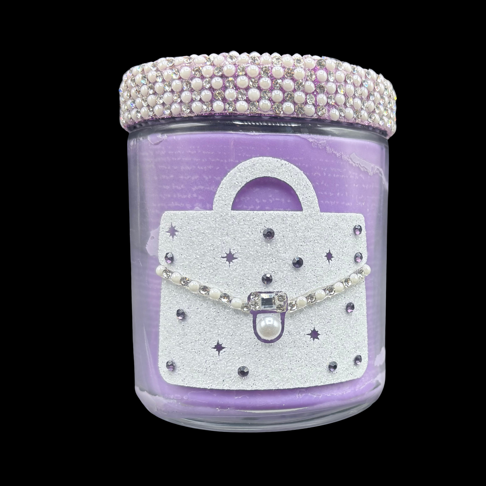 Decorative candle jar with a handbag design and pearl embellishments on a black background