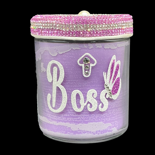 Decorative jar with 'Boss' text and pink lid on a black background