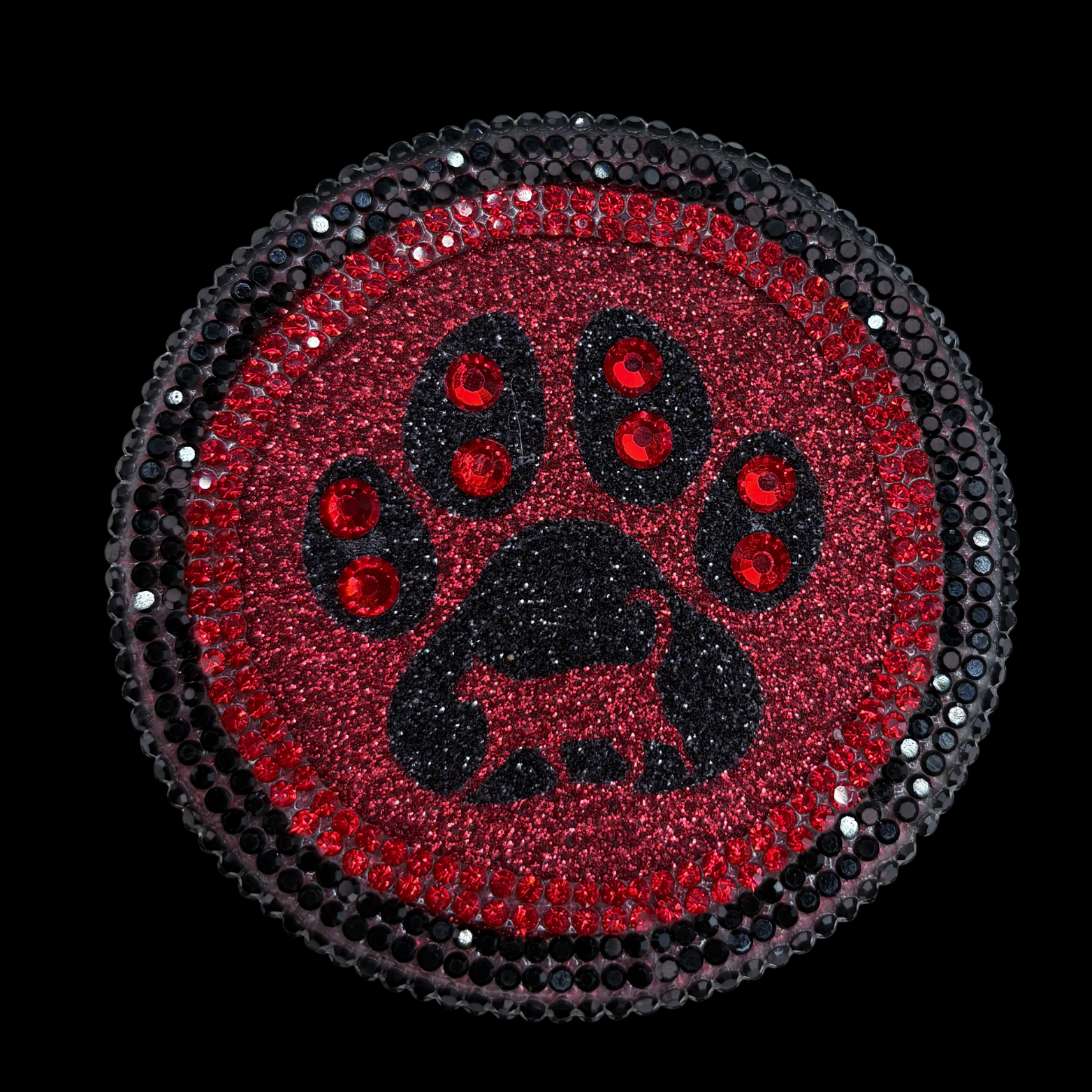 Circular patch with black paw print and red accents on a black background