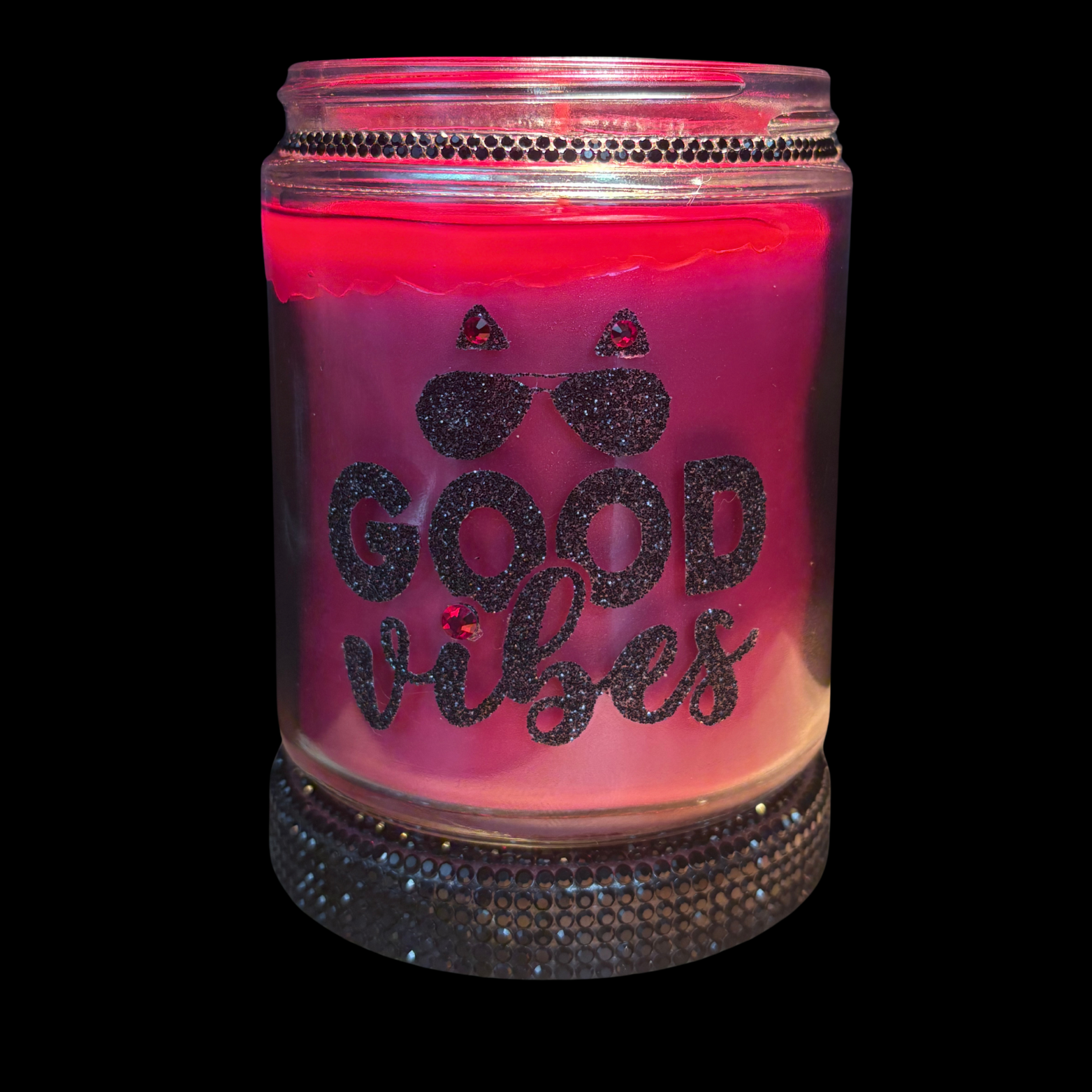 Pink candle in a jar with 'Good Vibes' text on a black background