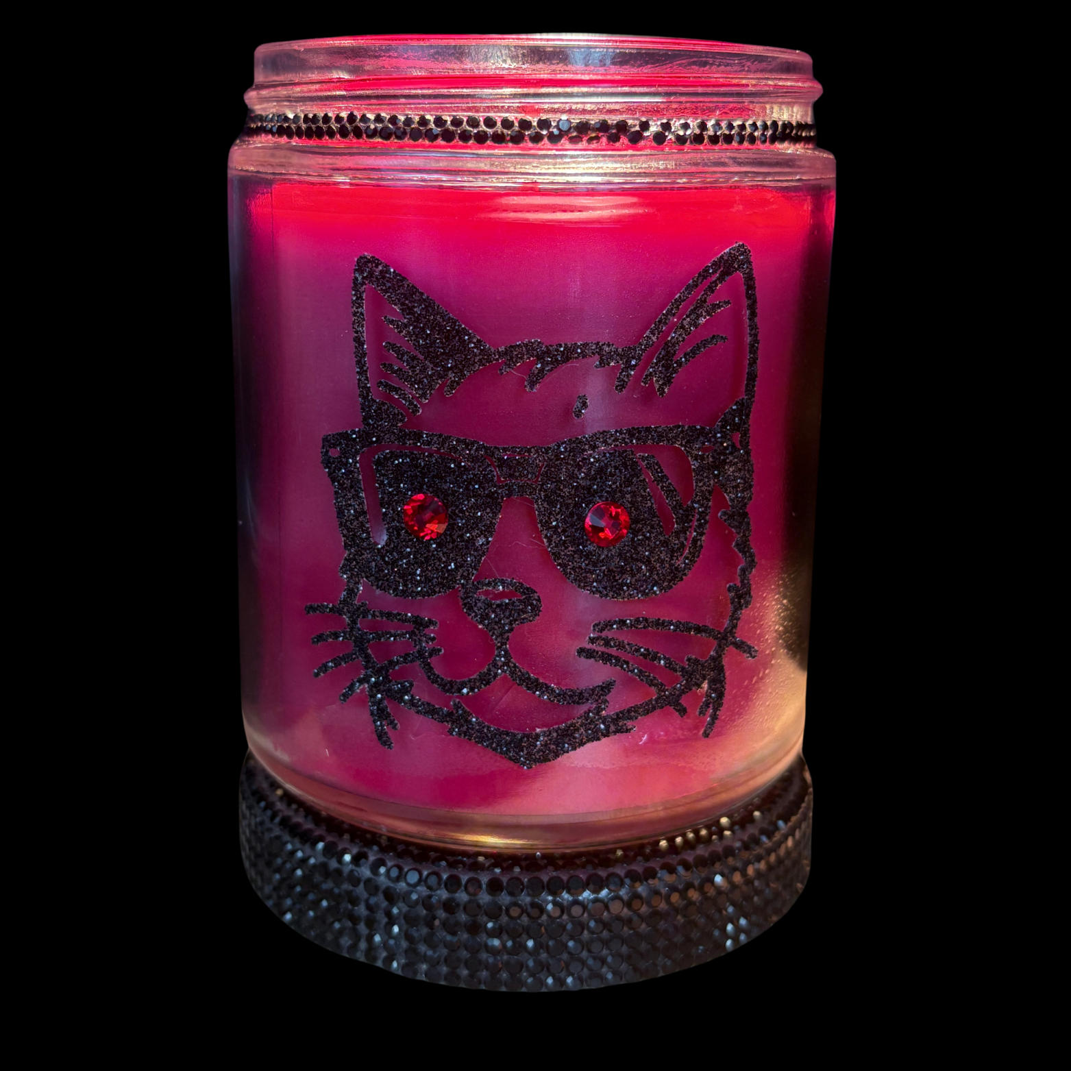 Pink candle in a jar with a black cat design on a black background