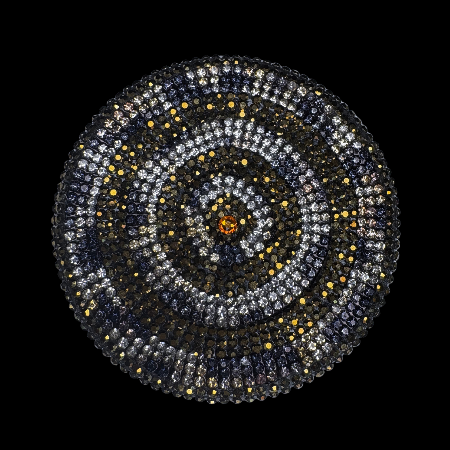 Circular pattern with concentric circles of stones on a black background