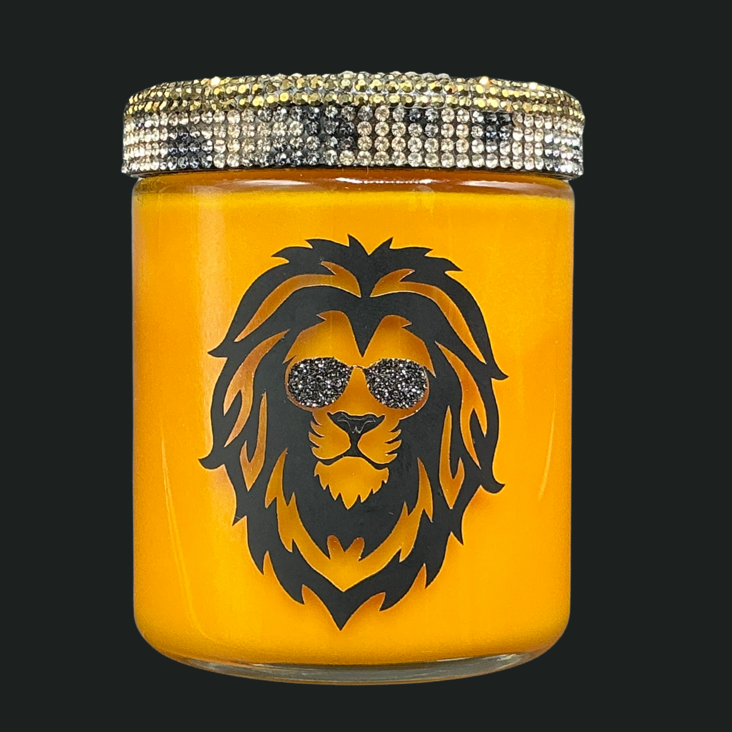 Yellow candle jar with a lion design and rhinestone lid on a black background
