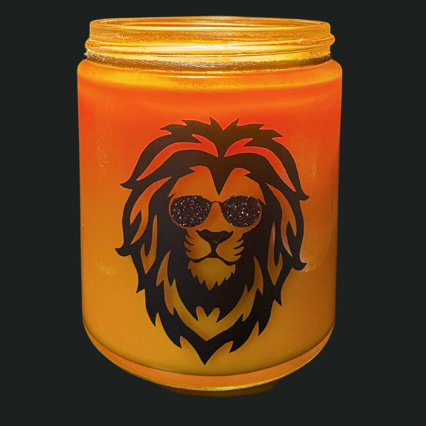 Candle in a jar with a lion design wearing sunglasses on a black background