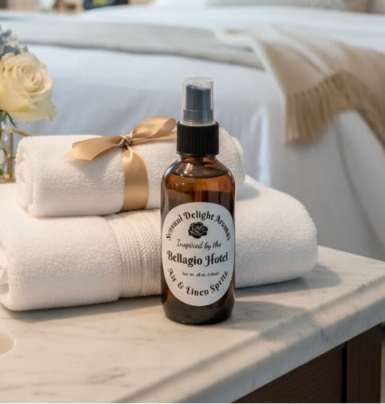 Bottle of air and linen spray with towels on a marble surface