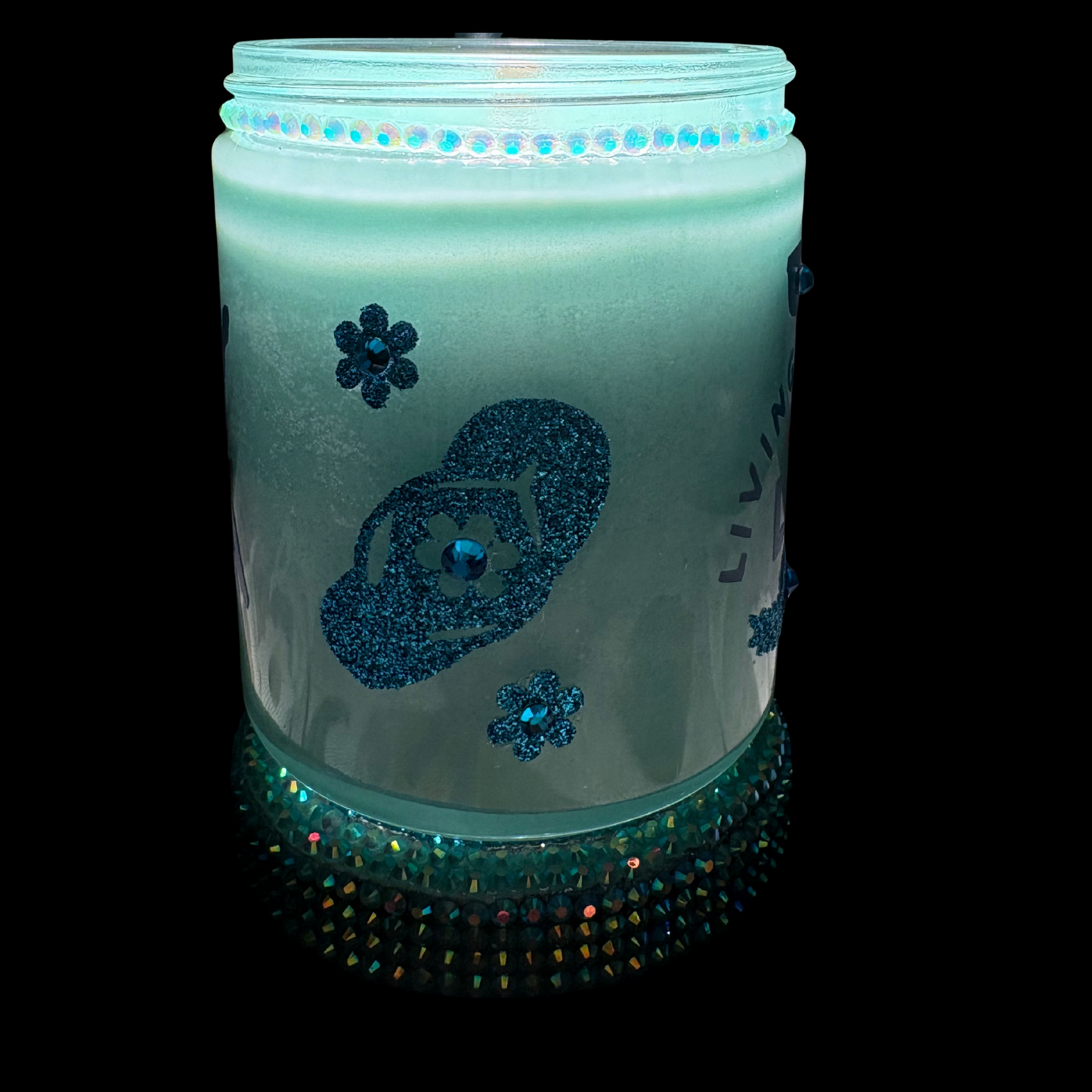 Candle in a jar with decorative elements on a black background