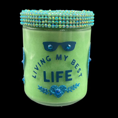 Green jar with decorative lid and embellishments on a black background