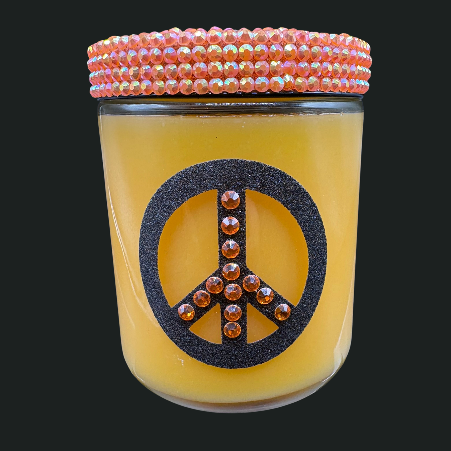 Glass jar with a peace symbol design and beaded lid on a black background