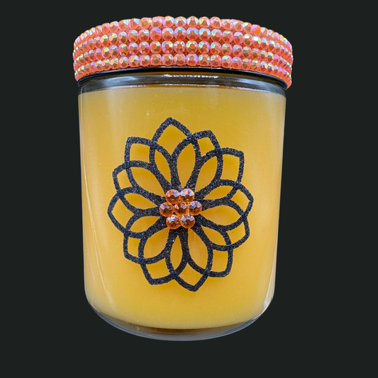 Glass jar with decorative lid featuring a floral design on a black background