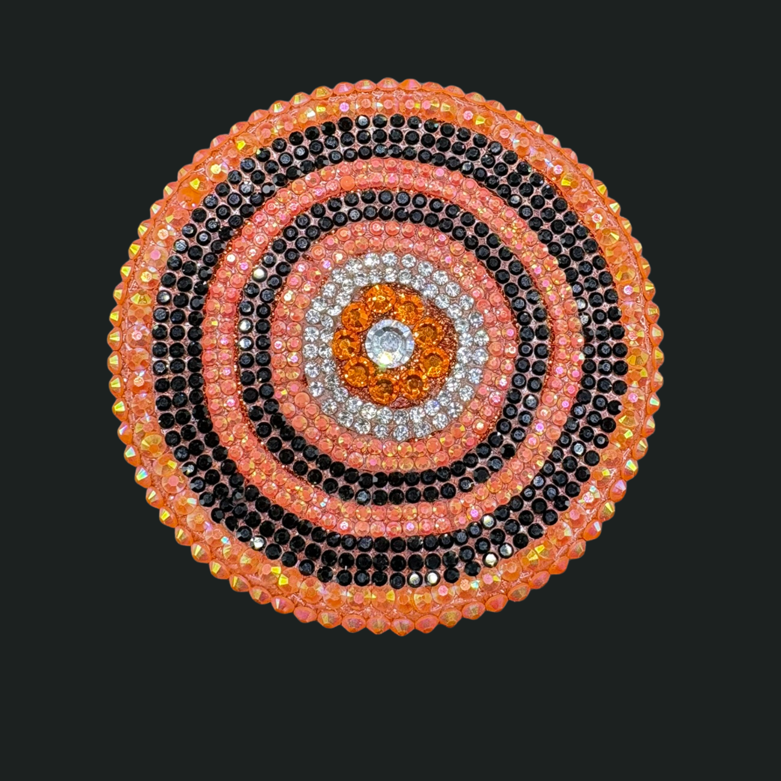 Circular design with concentric circles of beads on a black background