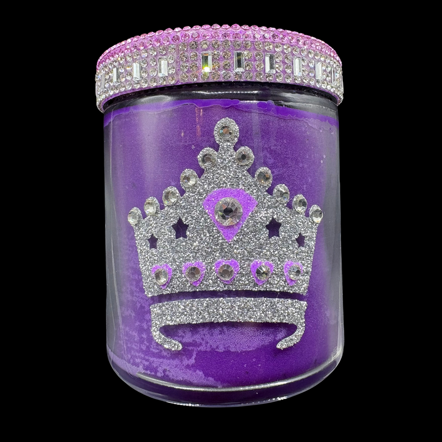 Purple jar with a decorative crown design and rhinestone lid on a black background
