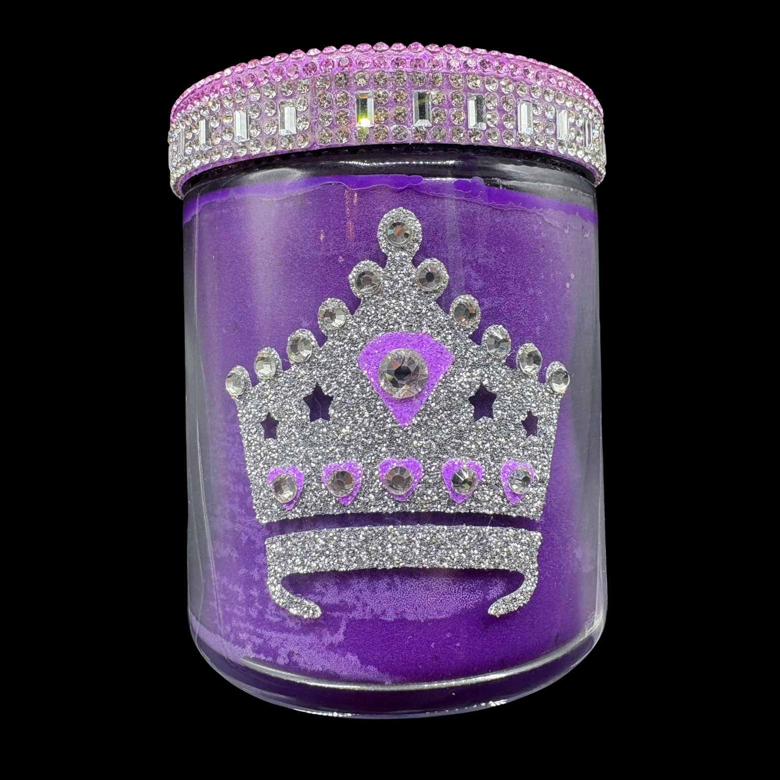 Purple jar with a decorative crown design and rhinestone lid on a black background