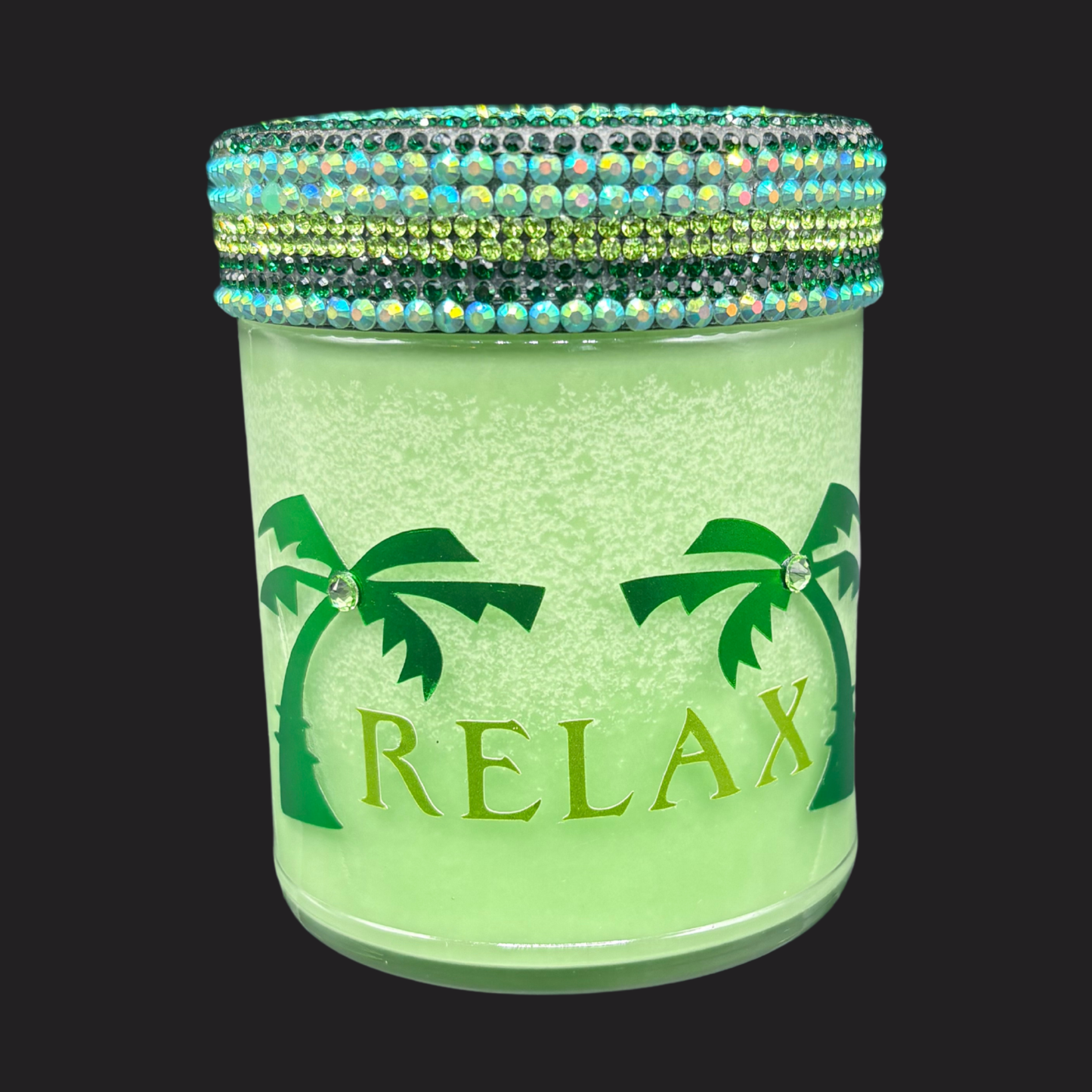 Green jar with palm tree design and 'RELAX' text, decorated with colorful beads on a black background.