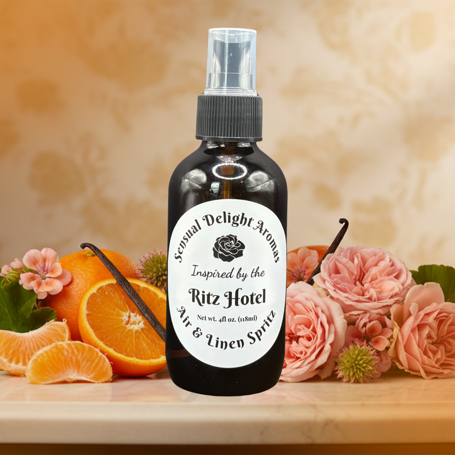 Bottle of 'Sexual Delight Aroma' Ritz Hotel air and linen spray with flowers and oranges on a wooden surface.