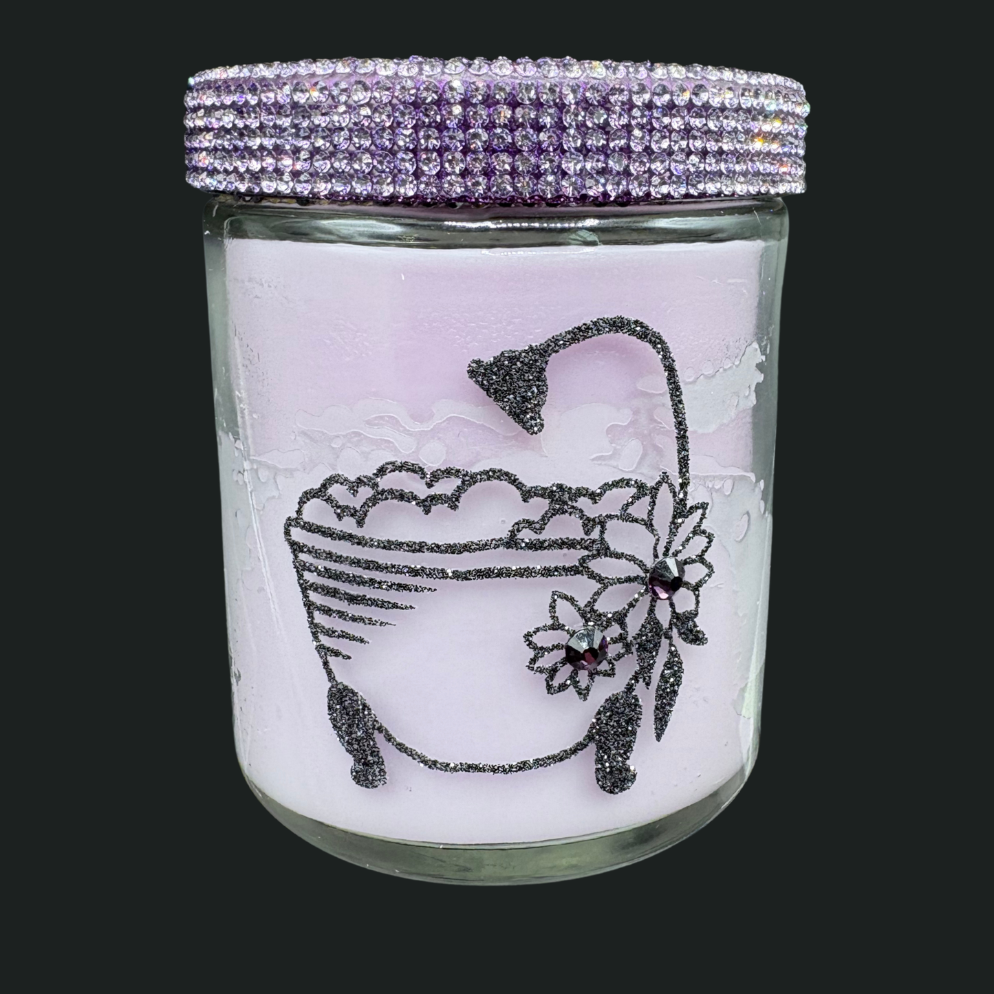 Glass jar with decorative lid featuring a bathtub and flower design on a black background