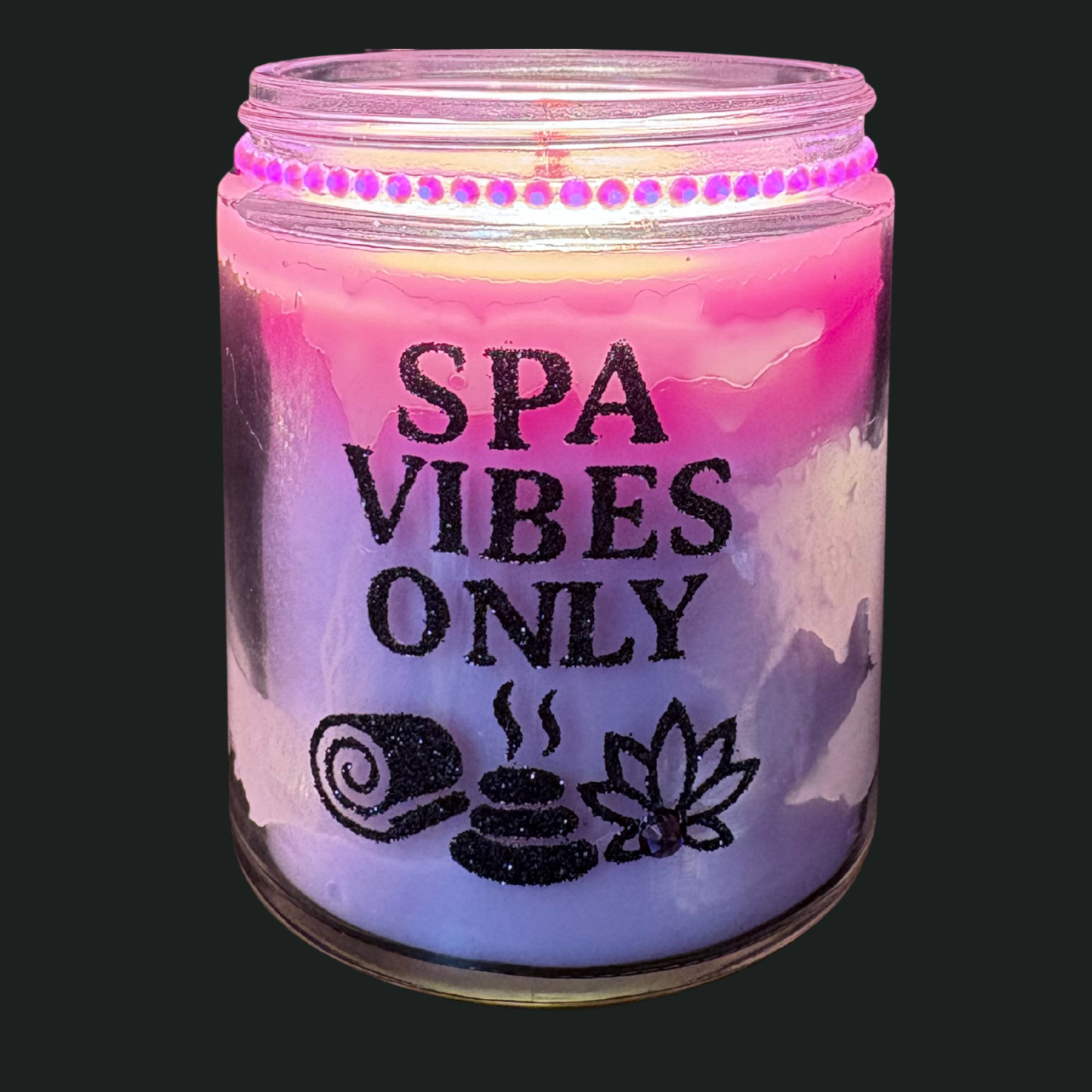Candle jar with 'SPA VIBES ONLY' text and symbols on a black background