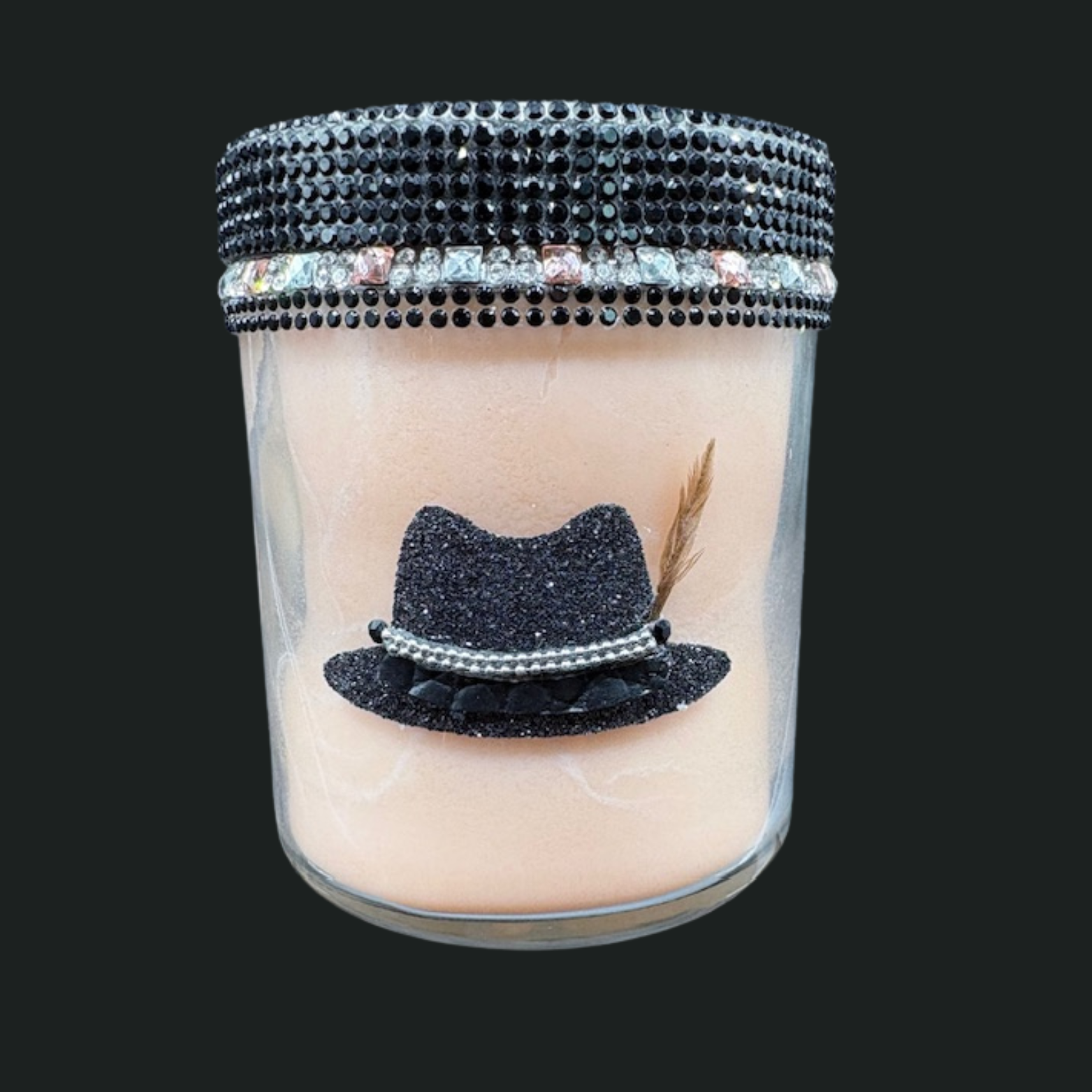 Candle with a decorative black hat and feather on top, featuring a bejeweled lid.
