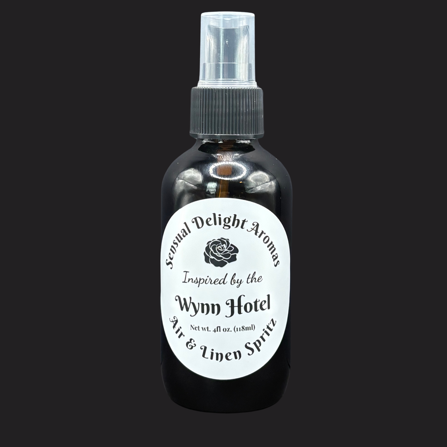 Bottle of air and linen spray from Sexual Delight Aromas inspired by the Wynn Hotel on a black background.